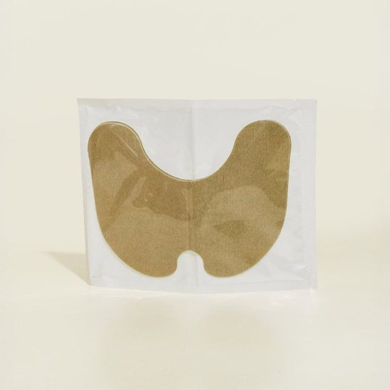 בתמונה, מדבקת בד חומה בצורת האות "U" הפוכה, ארוזה בשקית ניילון שקופה.